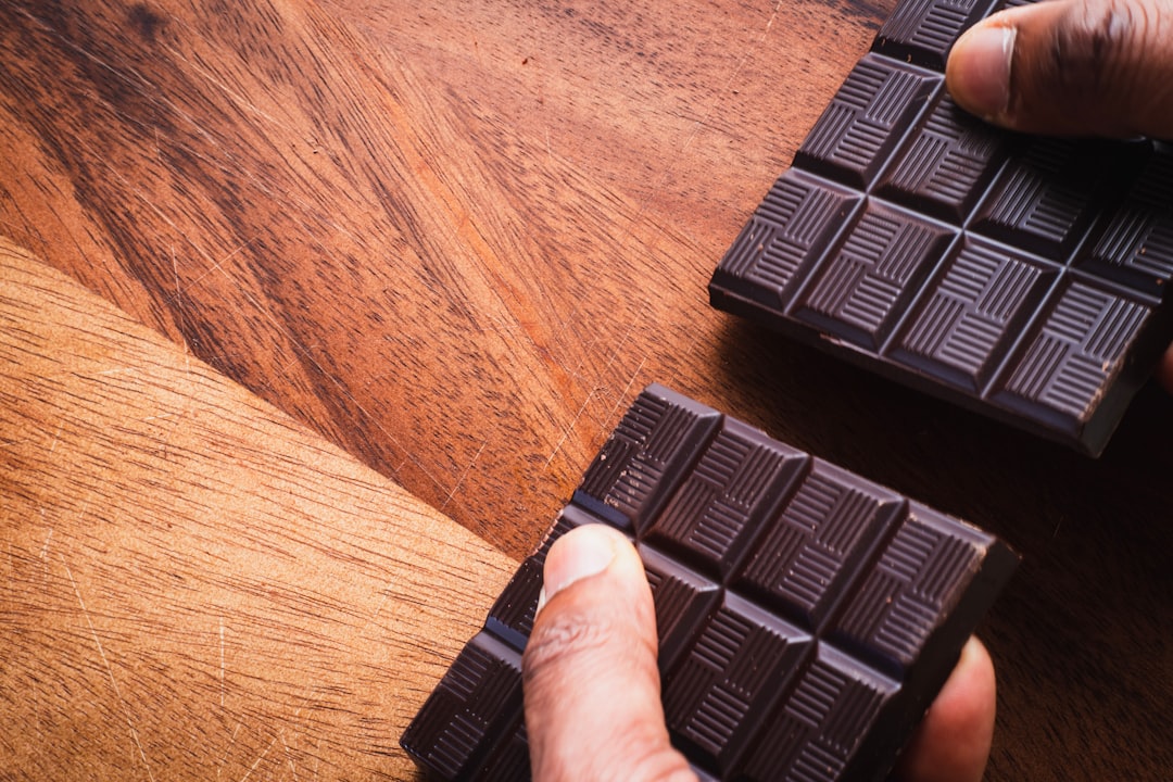 black plastic keyboard on brown wooden table
