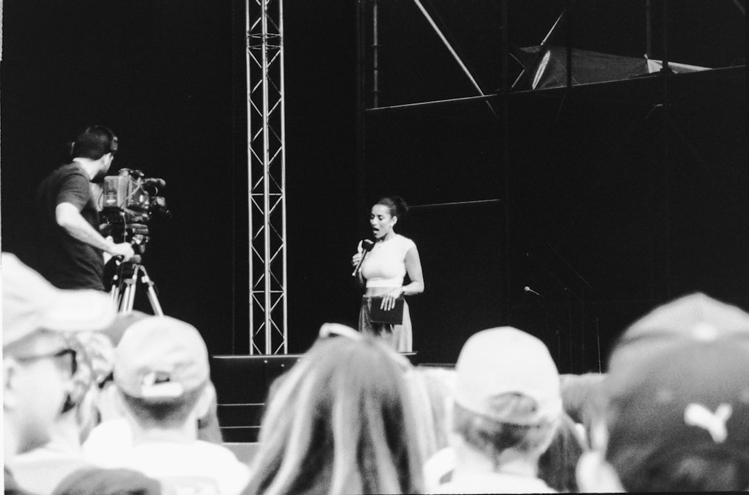 Woman speaking on stage with cameraman