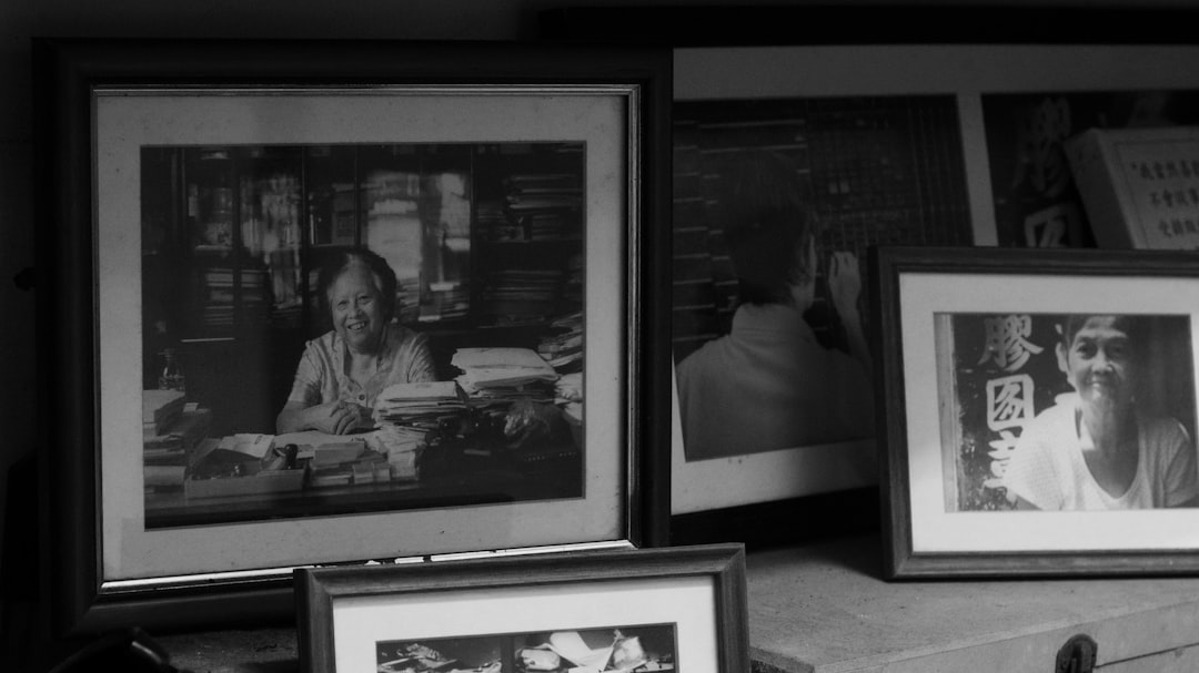 Framed black and white portraits on a shelf.