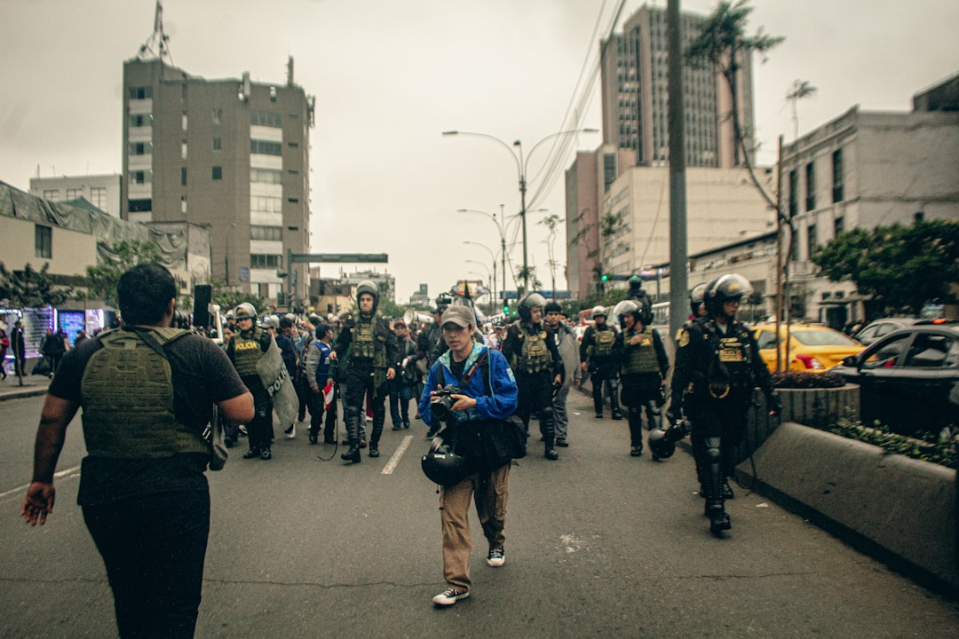 Protesters and police march down a city street.