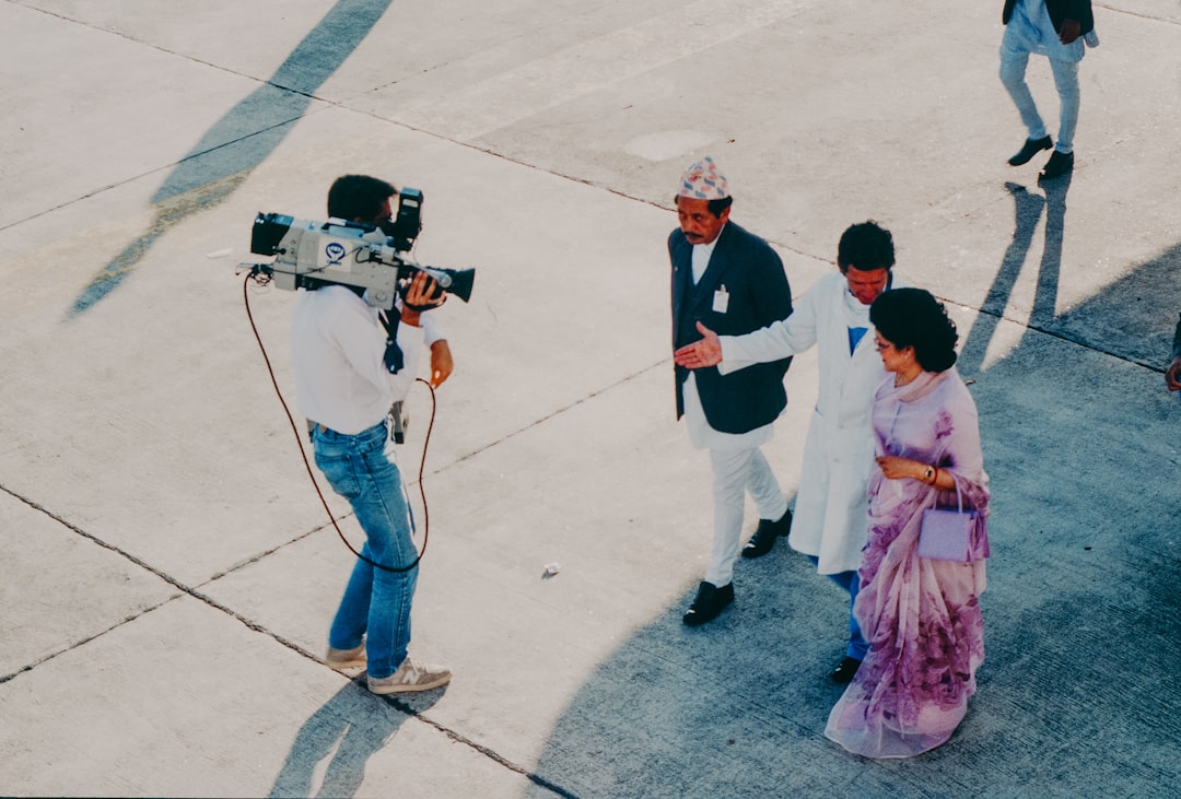 Cameraman films dignitaries arriving at event