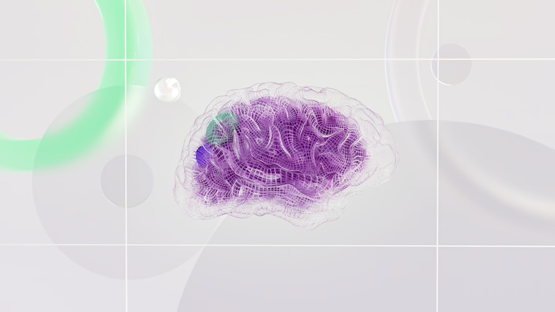A wireframe human brain with purple and green highlights on a light background