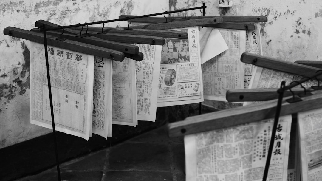Newspapers hanging on wooden racks to dry